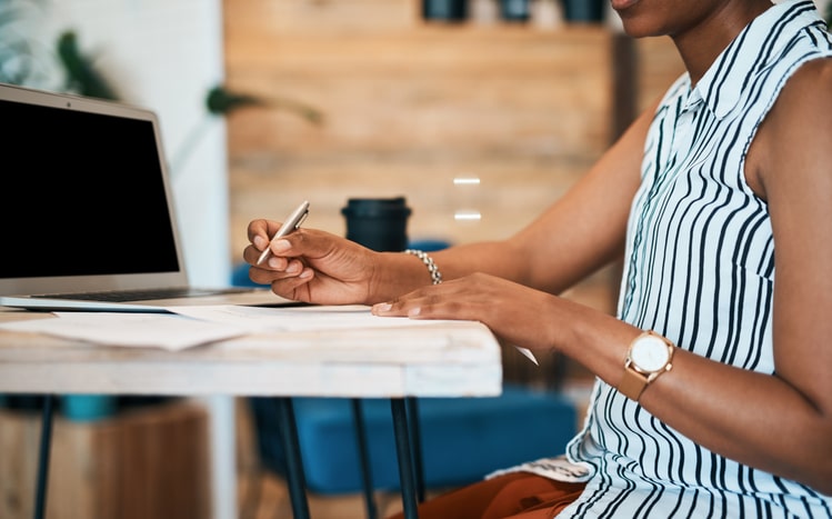 woman writing on document